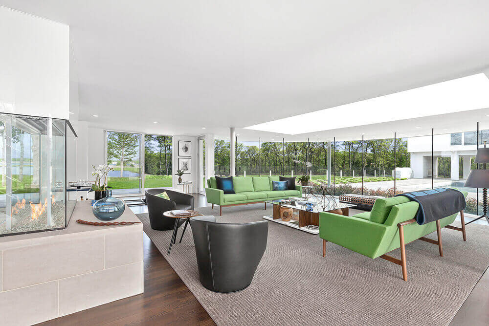 A living room with white walls and lime green couches | Corcoran