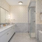 The master bath packs Carrara marble, a soaking tub, and radiant-heat floors.