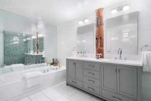 Period details are everywhere: Check out the terra cotta column between the vanity mirrors.