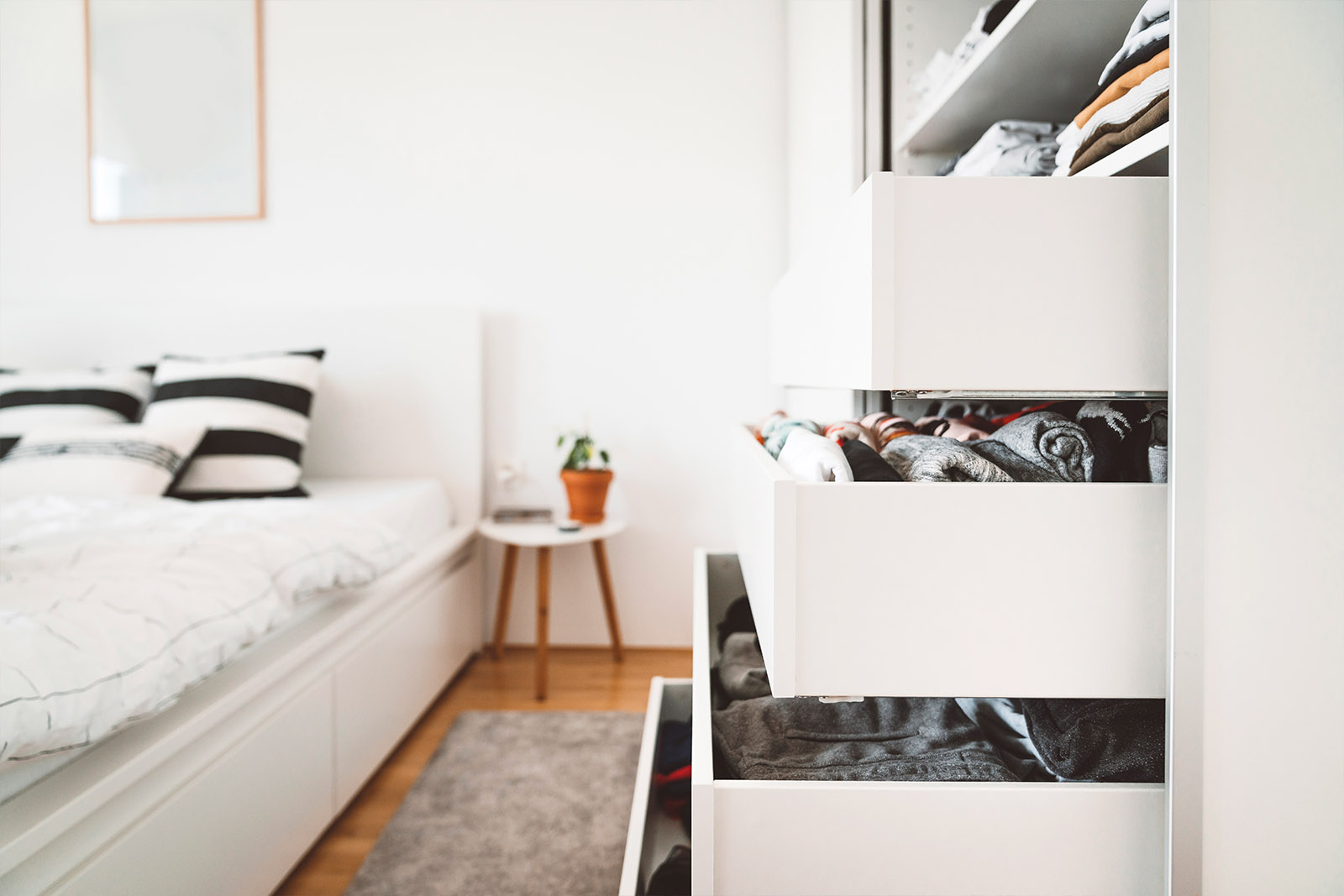 open bedroom drawers with clothes