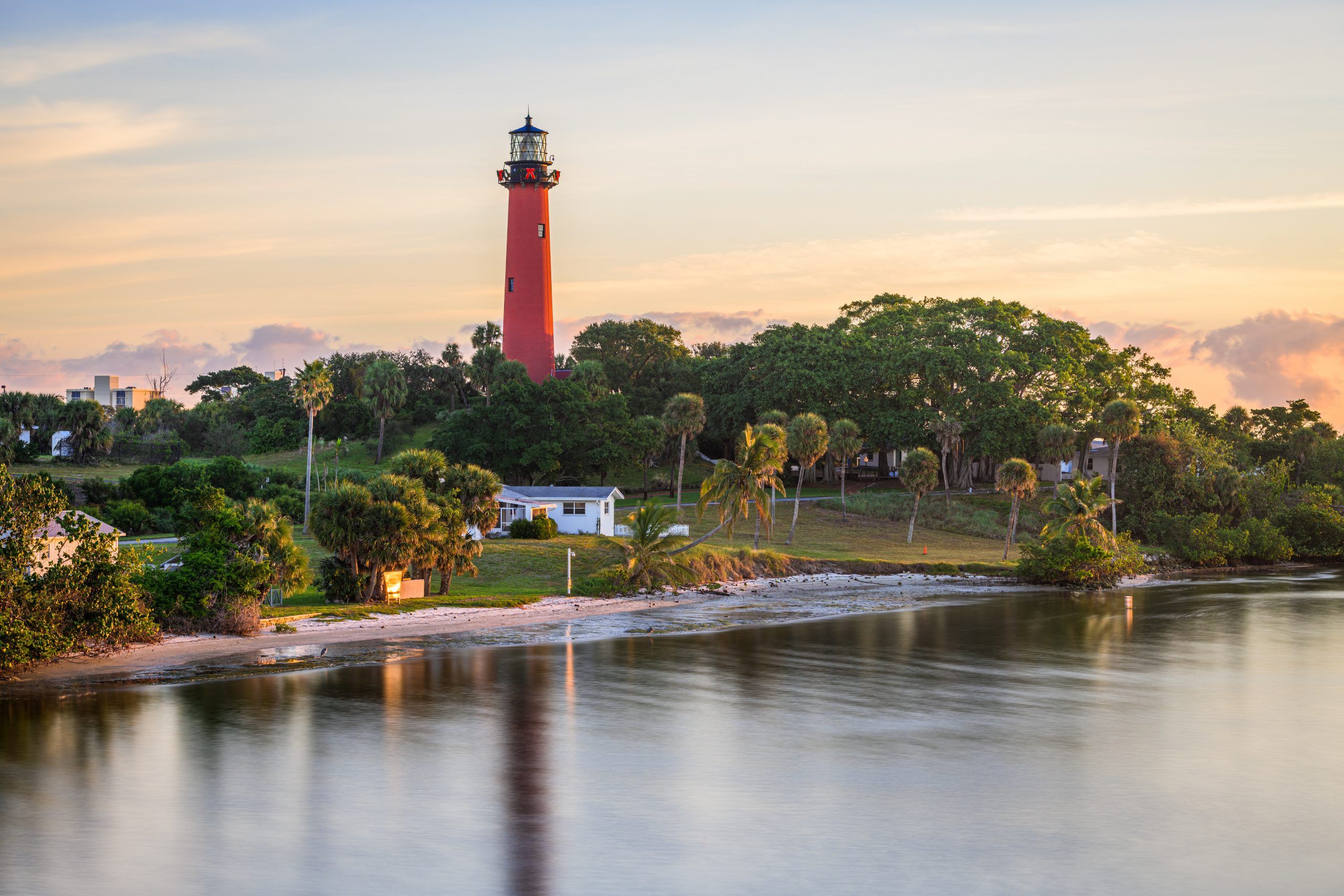 Jupiter Inlet Light towers over the Loxahatchee River in Jupiter, Florida at dawn.