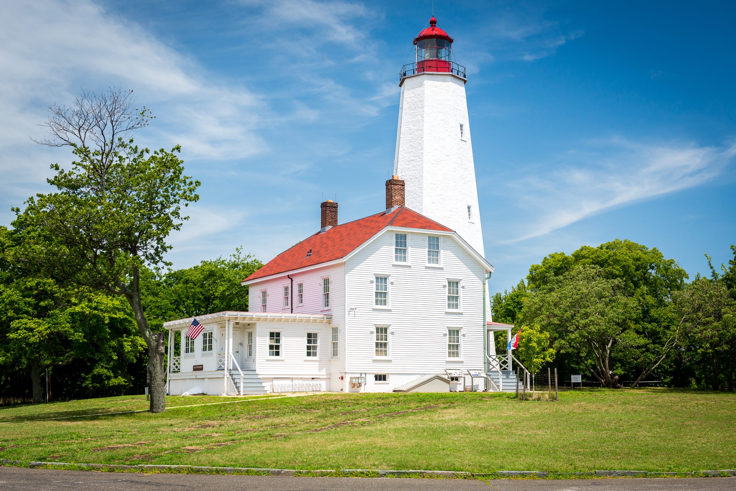 The Sandy Hook Light sits on a green field in Monmouth County, NJ.