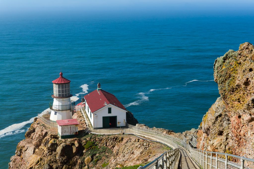 Point Reyes Light on the cliffs of Marin County, overlooking the vast blue Pacific Ocean.