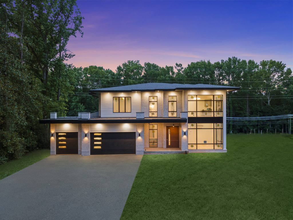 The interior of 4003 Columbine Circle shines invitingly at dusk in Charlotte.