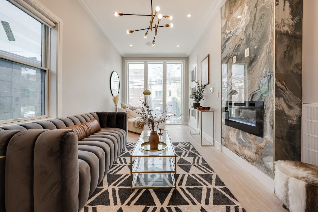 A floor-to-ceiling marble fireplace mantle is just one eye-catching aspect of the living room at 295 Terrace Ave in Jersey City.