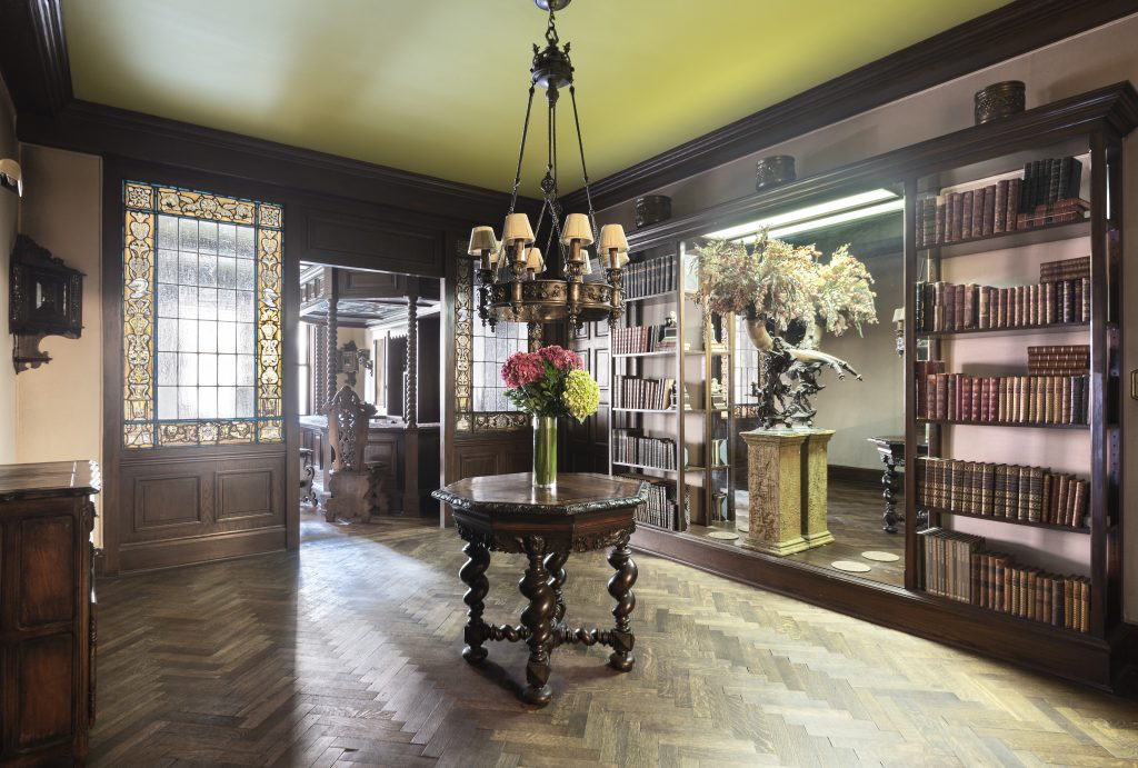 The entry gallery of apartment 3D at 125 East 72nd steps back in time with its parquet flooring and stained glass windows.