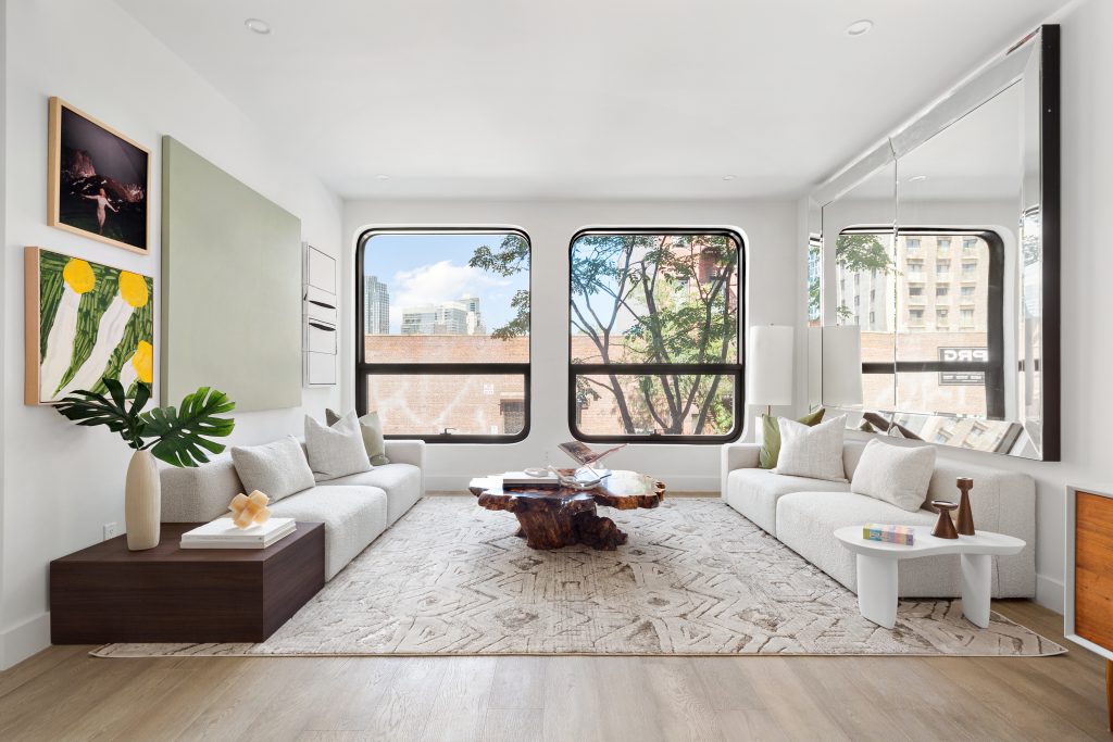 The living room at 74 South 2nd Street floats above the first floor and looks out to Williamsburg through curved windows.