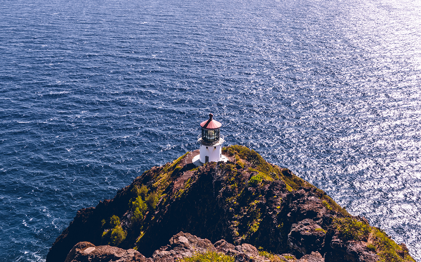 Impossibly blue waters loom large behind the Makapu'u Point Lighthouse, perched at the end of a cliff and ready to guide ships in Oahu.