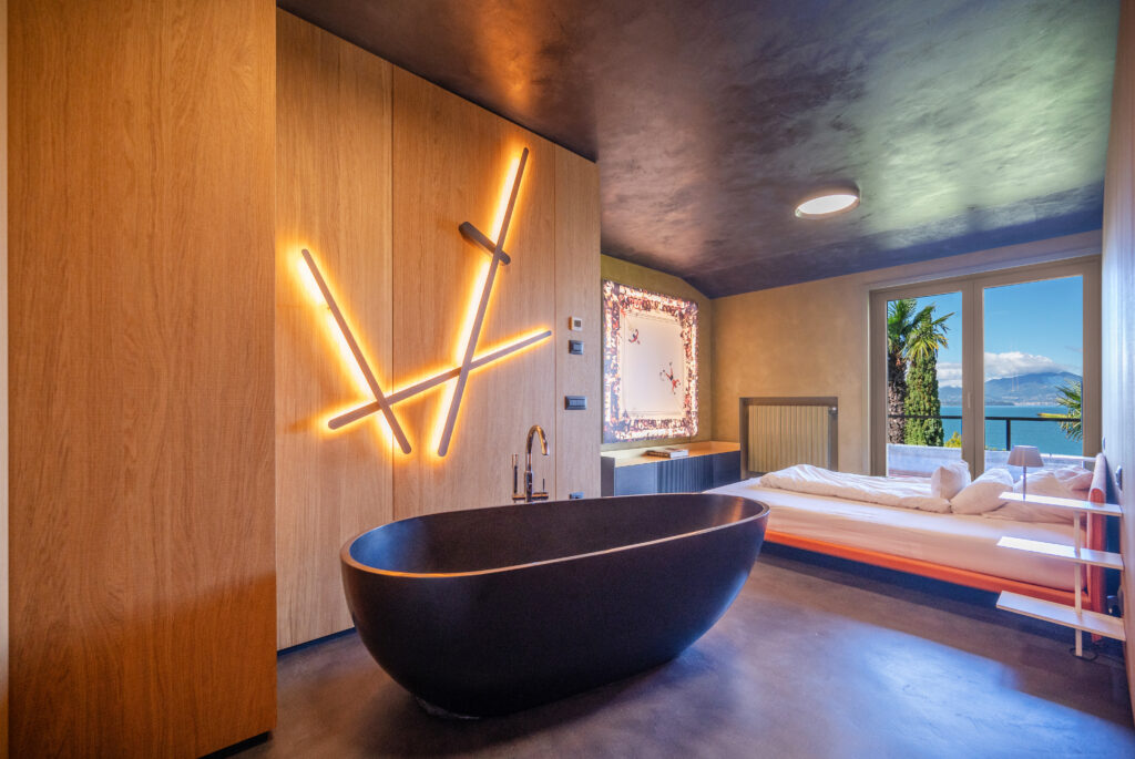 The black bathtub at this Italian villa resembles a sliced open avocado.