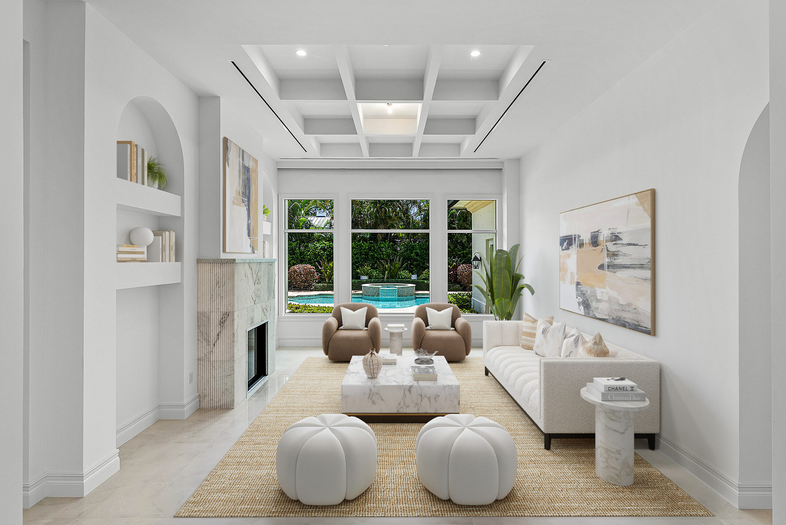 Elegant living room with coffered ceiling, marble fireplace, contemporary furniture, large window view of pool and garden, abstract artwork, and built-in bookshelves.