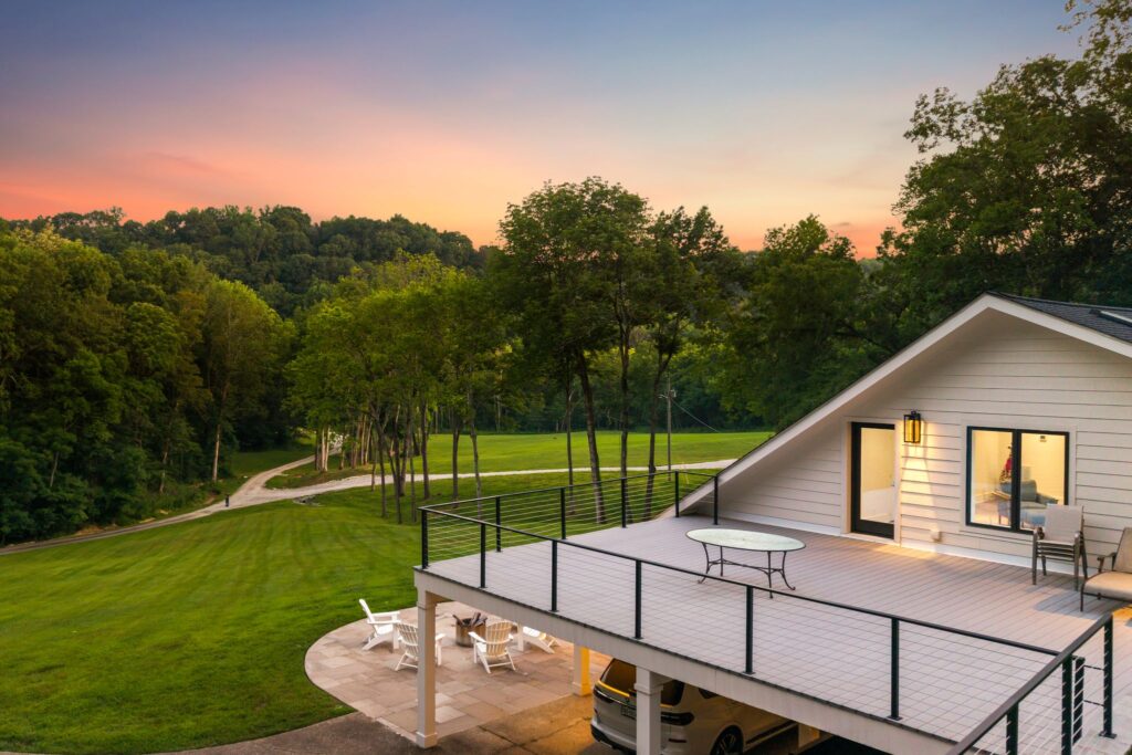 A modern white house with a large rooftop deck.