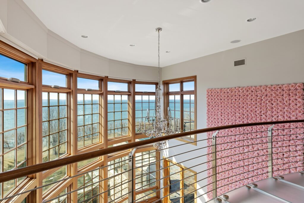 25 Rawson Road Sag Harbor, NY 11963 View of the Peconic Bay from the mezzanine level of a great room with floor to ceiling windows.