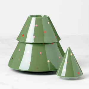Two green, cone-shaped ceramic containers with shiny finishes are placed side by side. Perfect for displaying near cookbooks, the larger container is decorated with small, colorful dots like a stylized Christmas tree; the smaller one is plain.