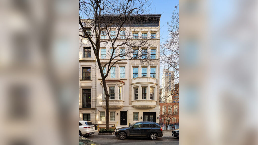 A city street with parked cars in front of multi-story townhouses, featuring large windows, bay windows, balconies, and decorative stonework; during Pisces season, leafless trees line the sidewalk like silent markers of astrological houses.
