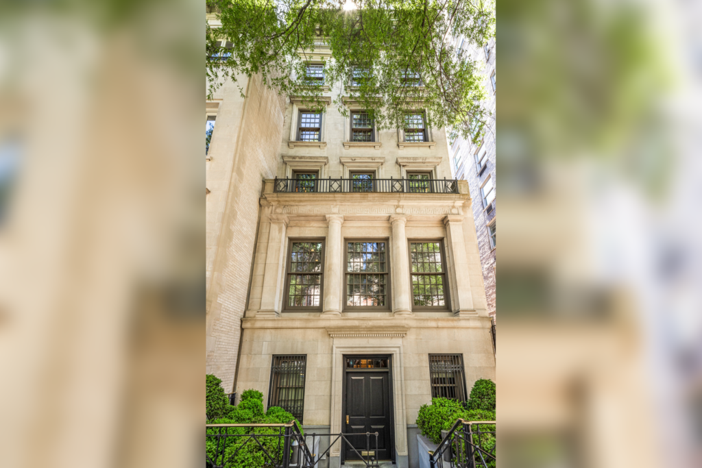 A tall, elegant townhouse with cream-colored stone walls, large windows, and black wrought iron railing welcomes you. Surrounded by lush greenery, its classical details shine bright.